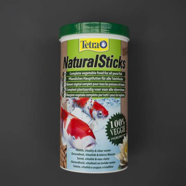 A tin of Tetra NaturalSticks fish food featuring images of goldfish and plants on the label.