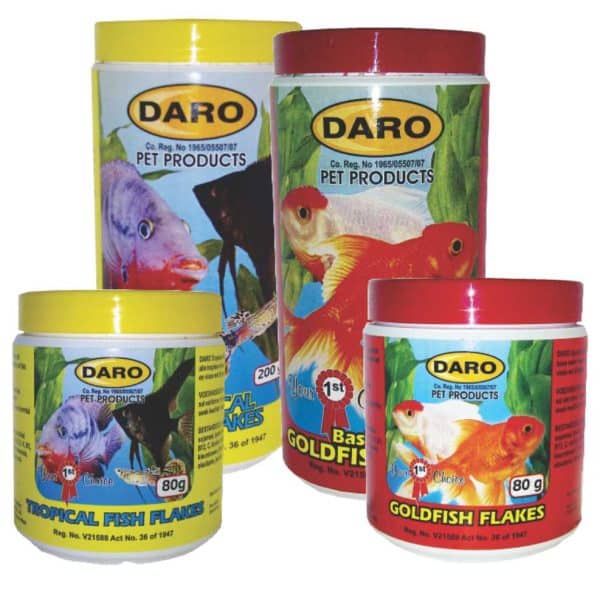 A close-up of four yellow and red tubs of Daro fish food and fish flakes.