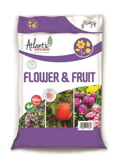 Bag of flower and fruit fertilizer with colorful images of blooms and produce.