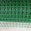 A close-up view of a green plastic mesh with a grid pattern.