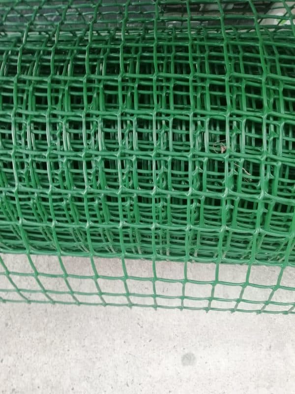 A close-up view of a green plastic mesh with a grid pattern.
