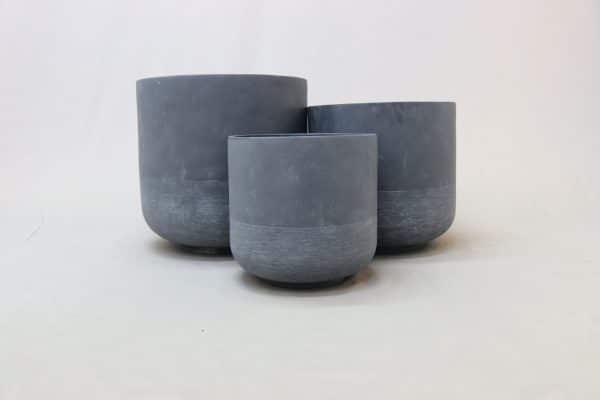 Three charcoal clay pots of various sizes against a white background.