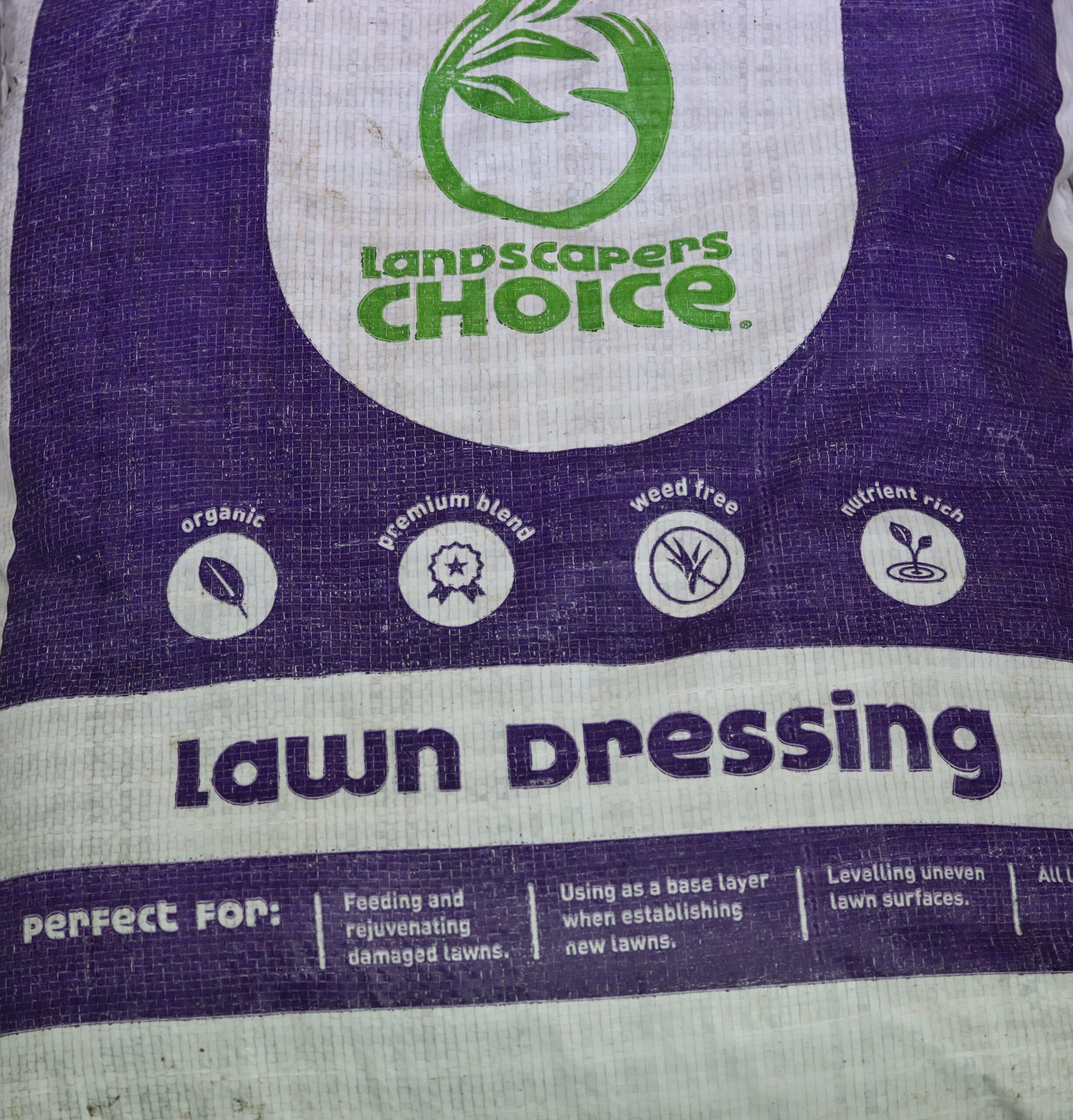 A purple and white bag of Landscapers Choice lawn dressing.