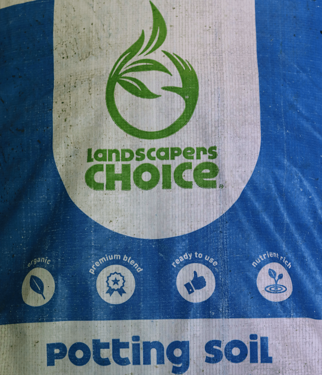 A blue and white bag of Landscapers Choice organic potting soil.
