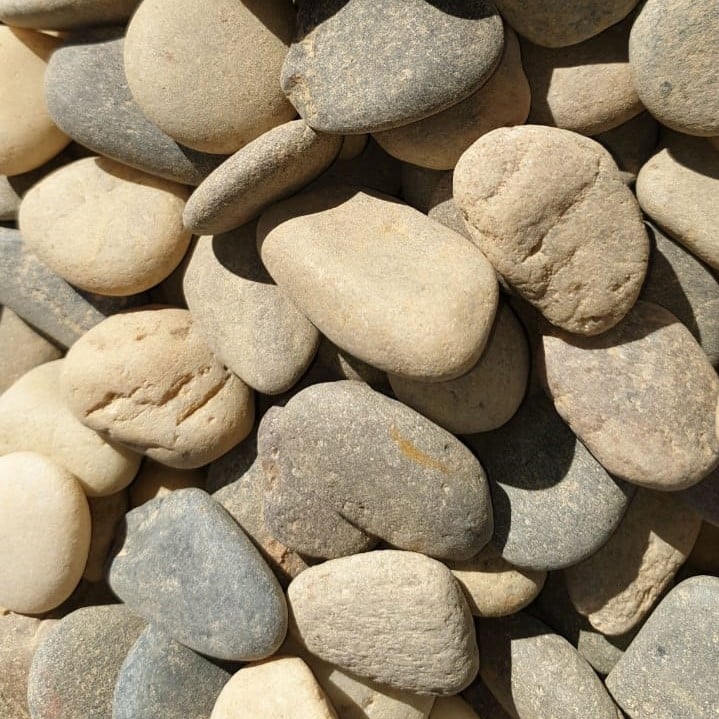 River rocks in shades of brown, beige, and grey.