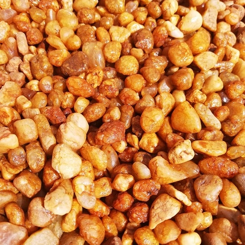 A large pile of small orange and kalahari red pebbles.