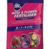 A pink and dark blue bag of rose and flower fertiliser weighing 2kg.