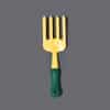 A small yellow gardening fork with a green handle.