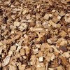 Pile of wood chips and shavings in shades of tan and brown.