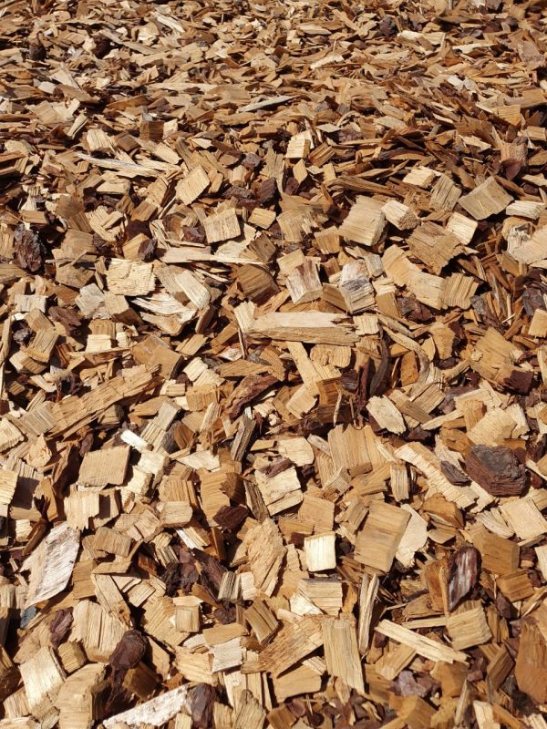 Pile of wood chips and shavings in shades of tan and brown.