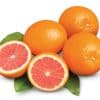 Whole oranges and halved grapefruit with green leaves.