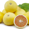 Grapefruit slices among whole yellow grapefruits and green leaves.