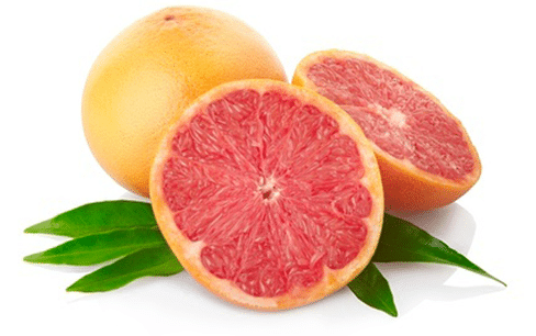 Cross-section of ripe grapefruit with juicy pink flesh and green leaves.