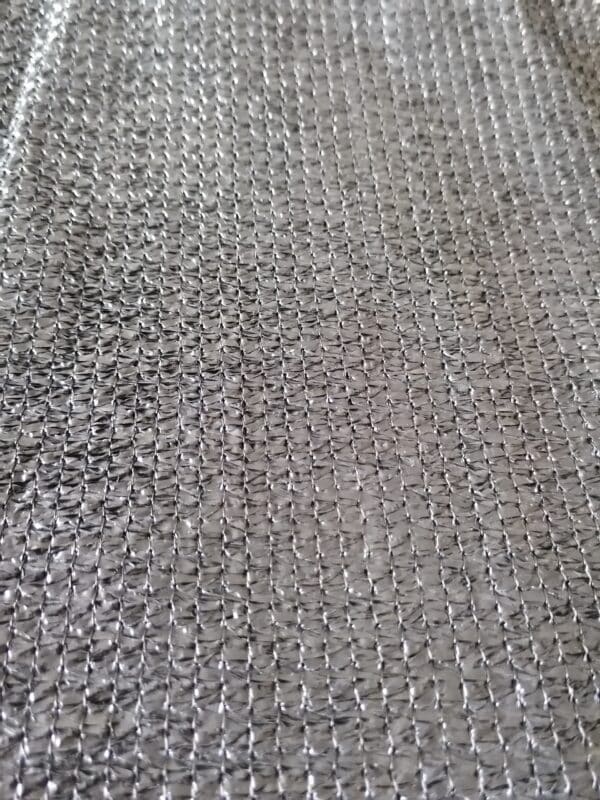 A close-up of silvery-black shade net.