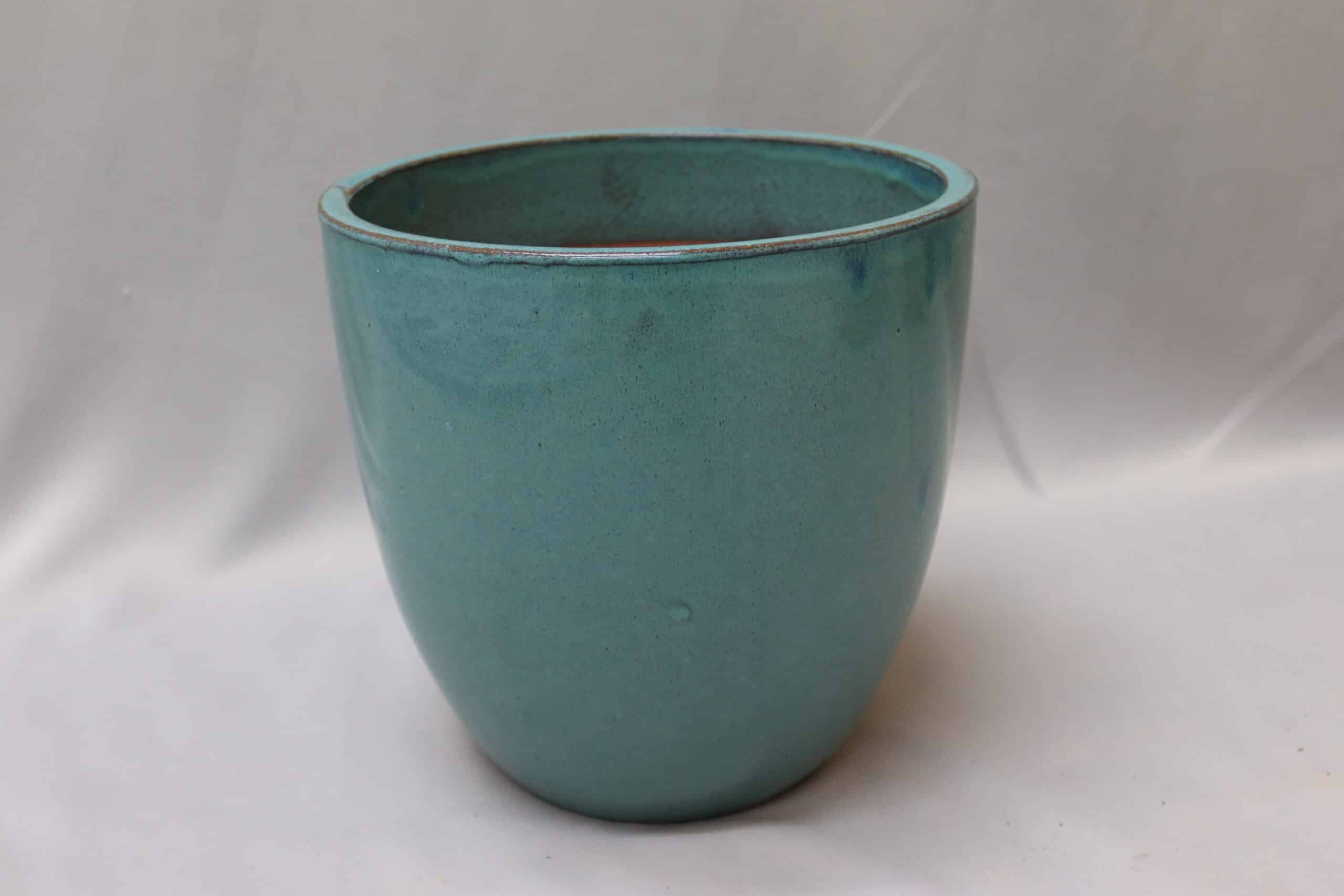Green egg-shaped glazed ceramic pot.