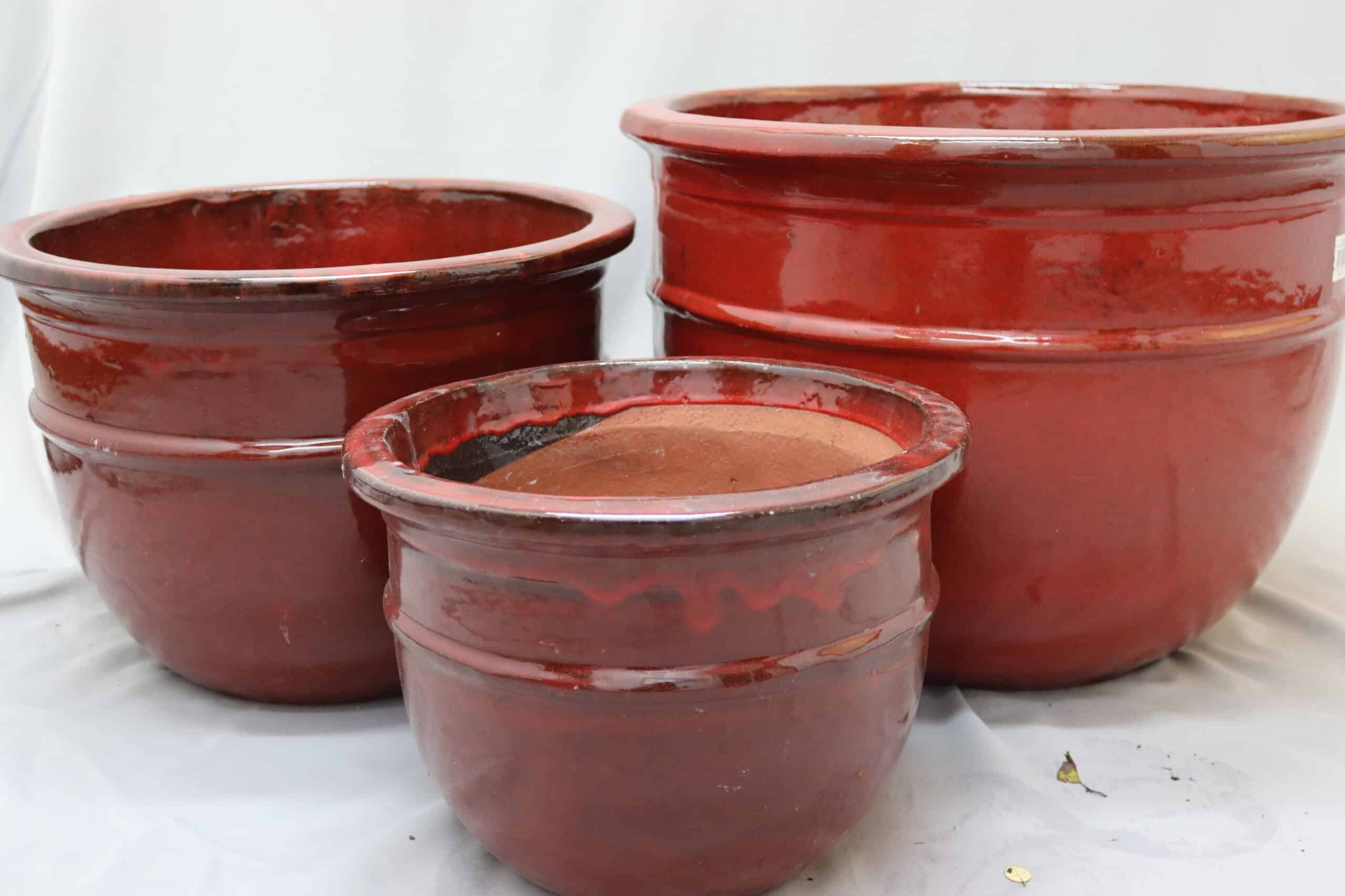 Large, medium and small glazed red belly wine plant pots.