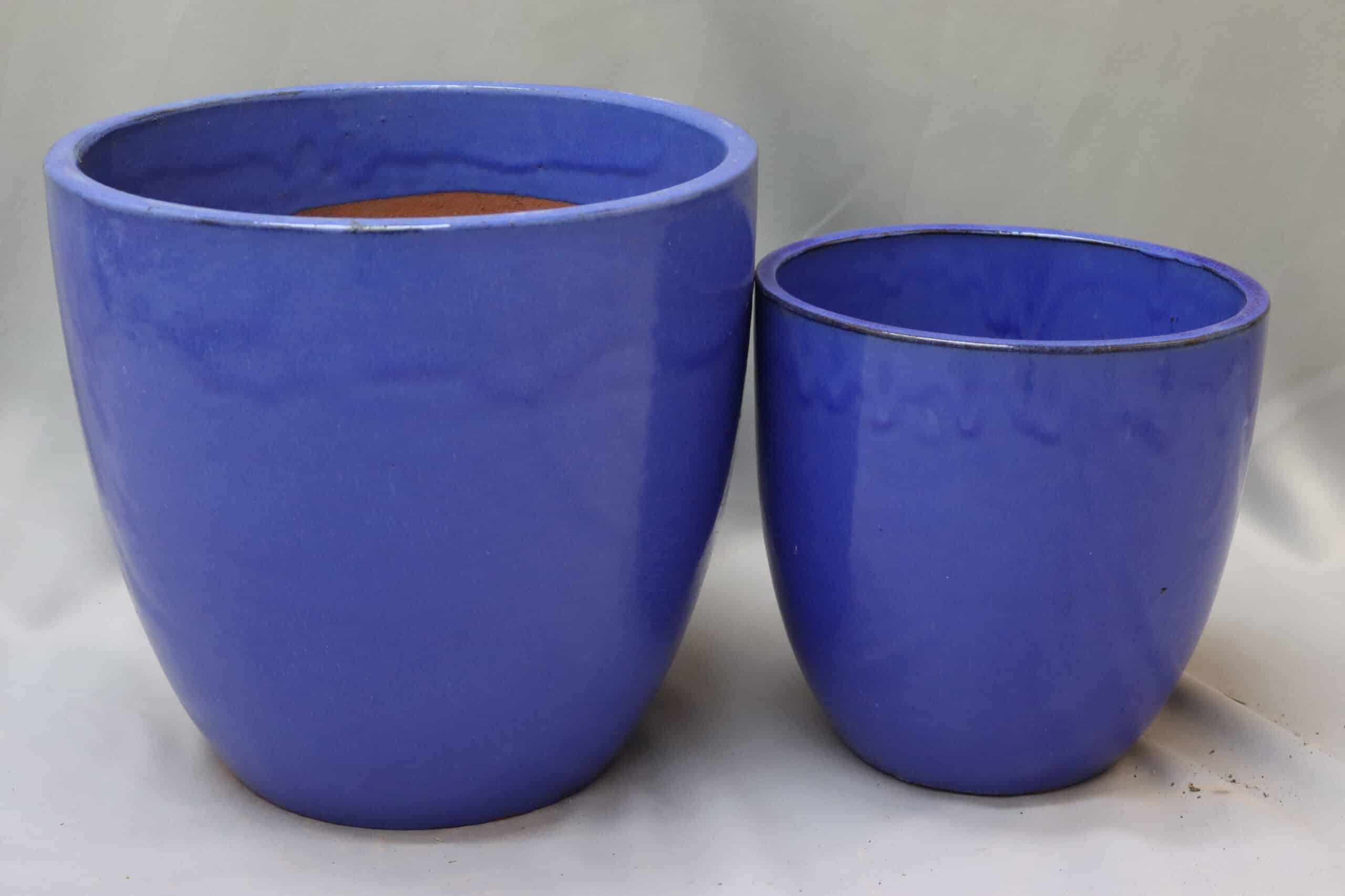 Large and medium glazed blue egg-shaped plant pots.