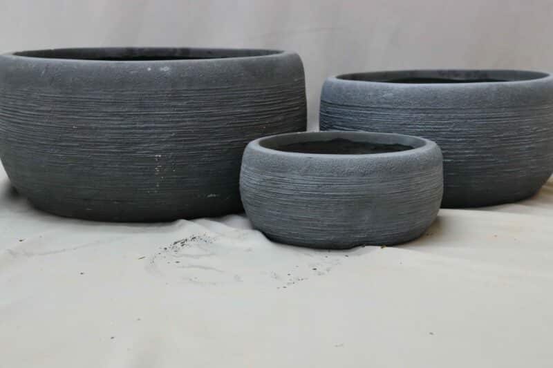 Large, medium and small round grey plant bowls in washed grey.
