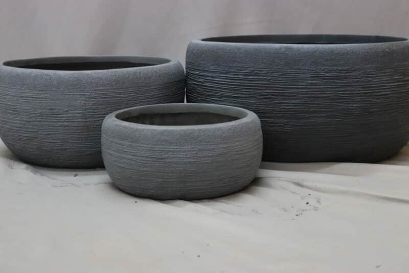 Large, medium and small round grey plant bowls in washed grey.