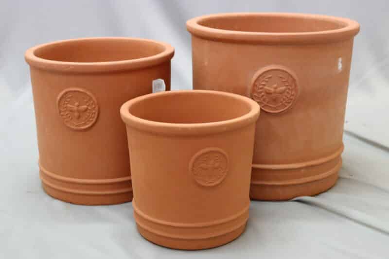 Three different-sized clay-coloured ceramic belly cylinder pots with embossing.