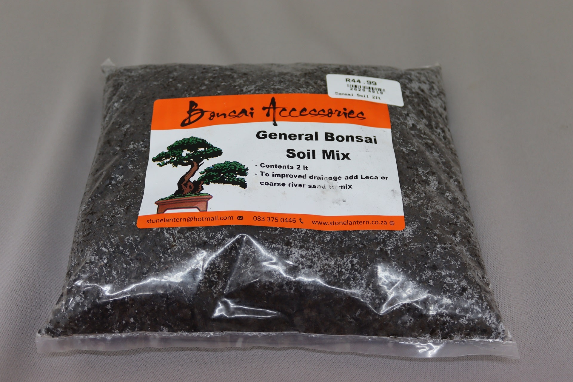 Transparant plastic bag containing black general bonsai soil mix.