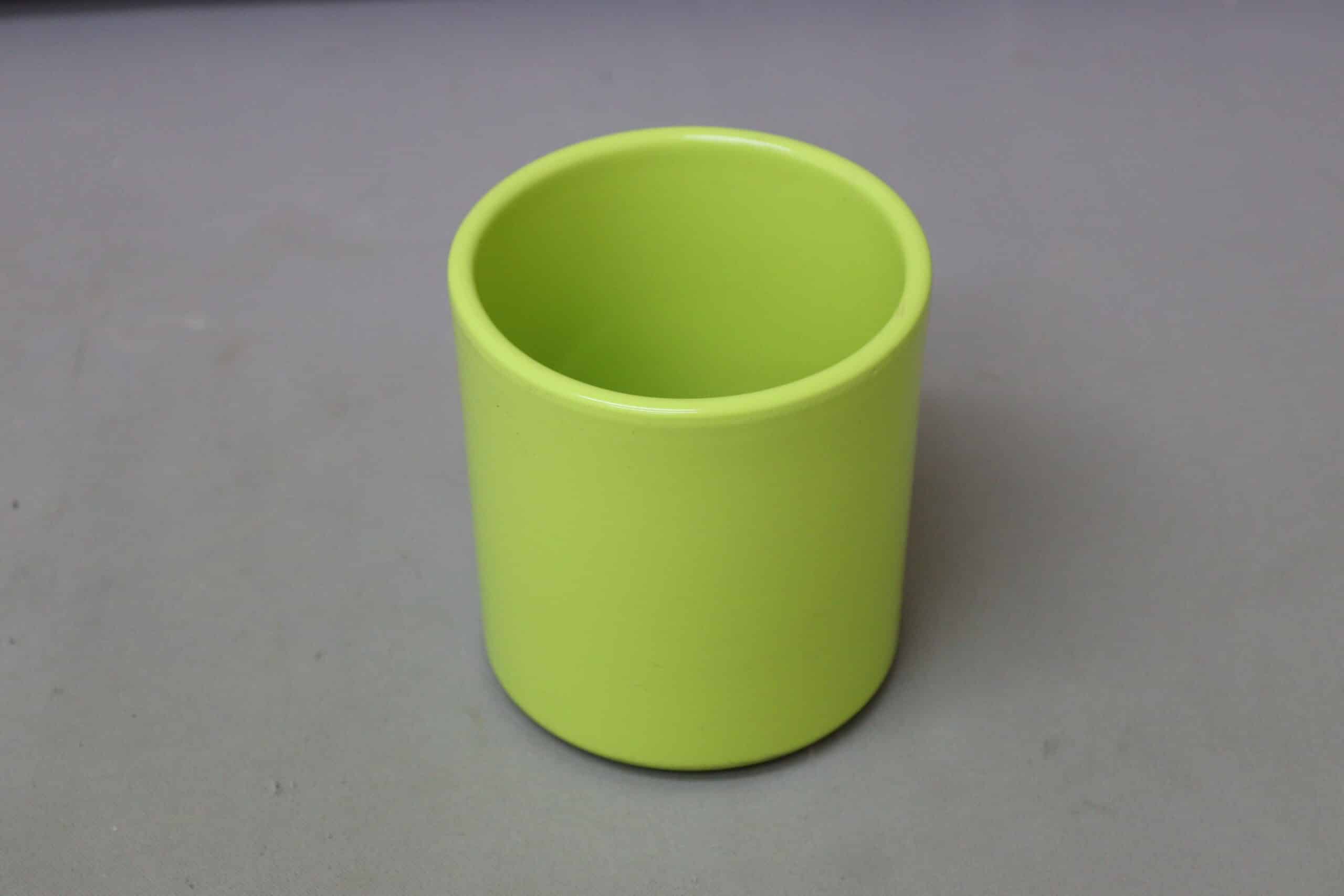 Smooth pastel green pot cover for potted plants.