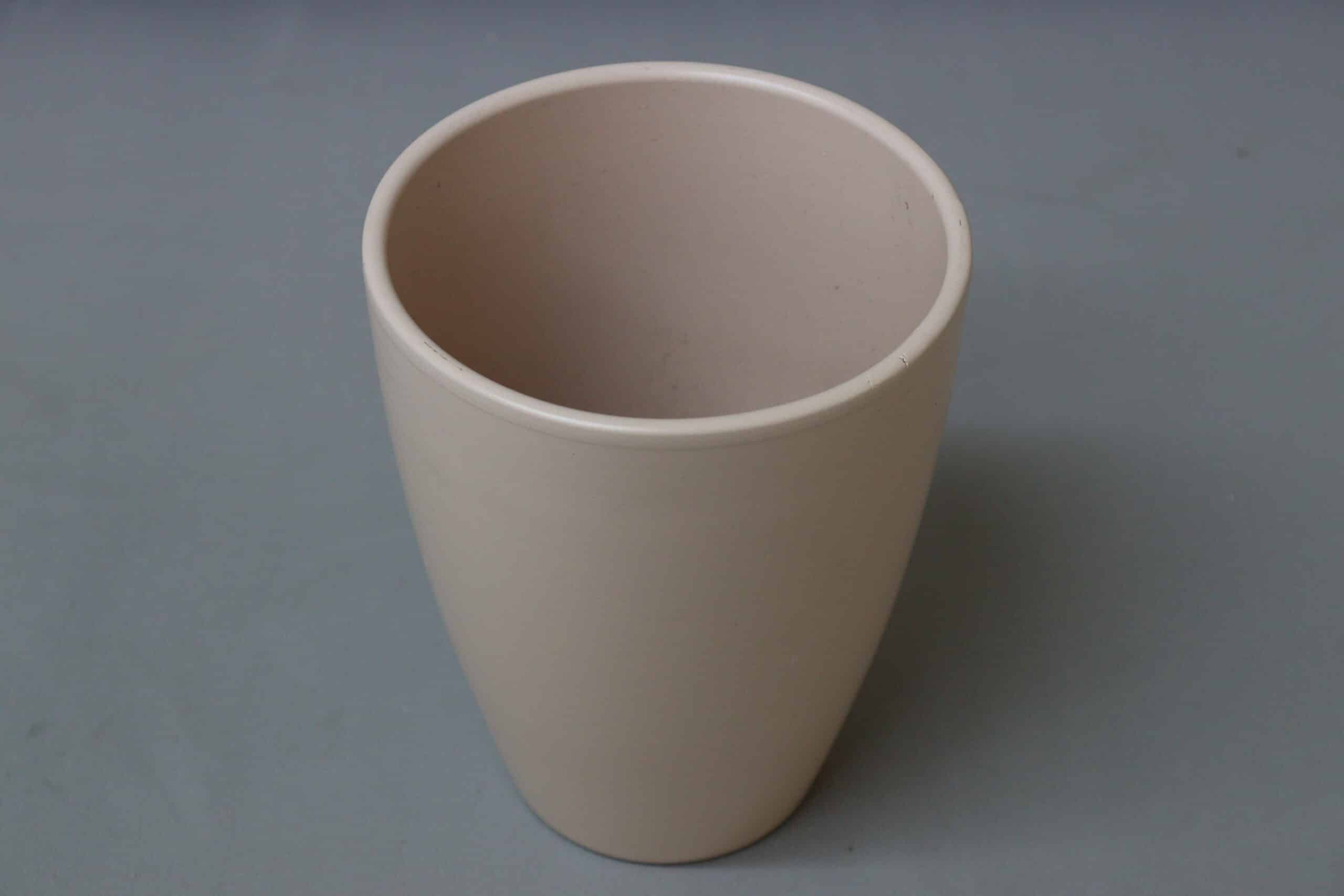Tall, smooth beige pot cover for potted plants.