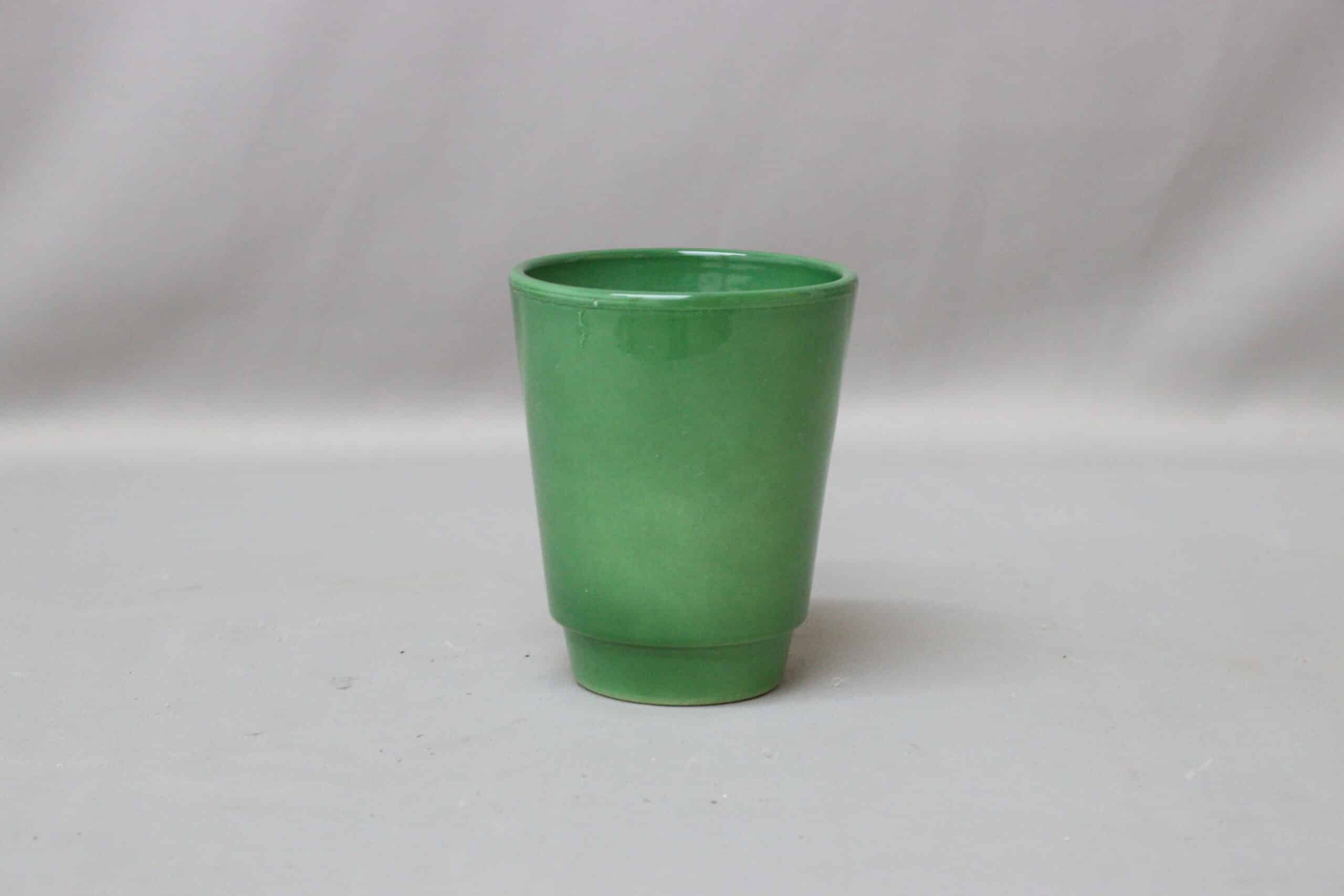 Bright green ceramic pot cover for potted plants.