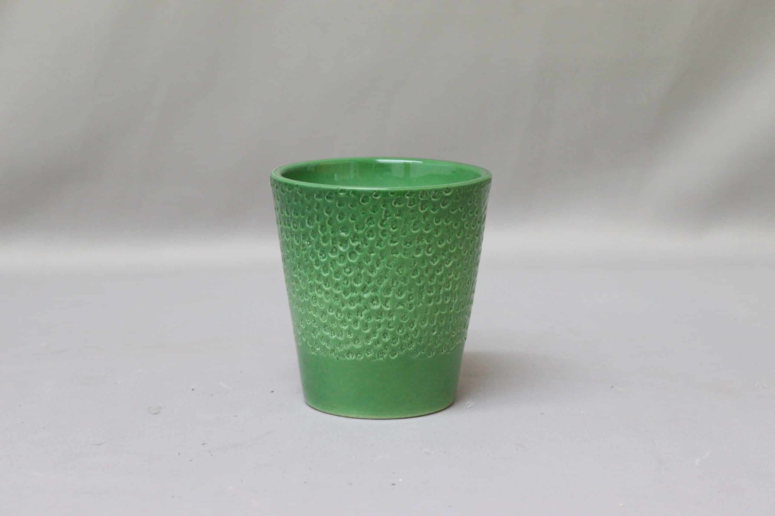 Textured bright green pot cover for potted plants.