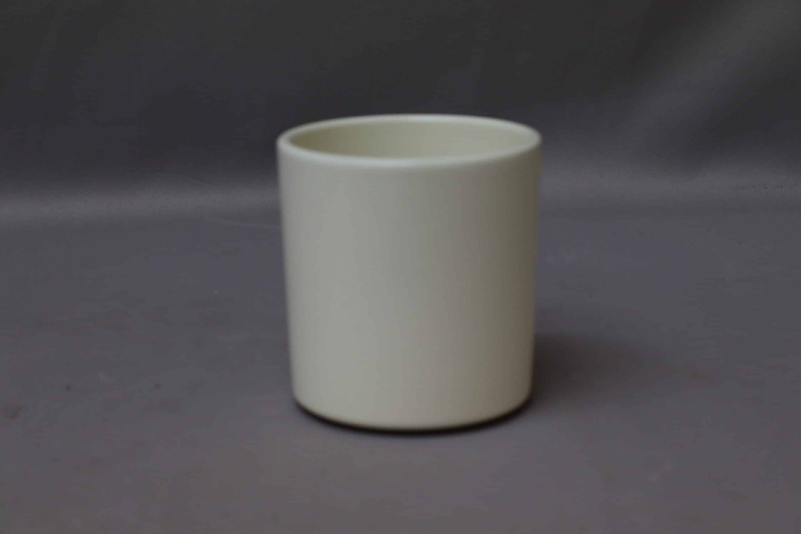 Smooth beige rounded pot cover for potted plants.