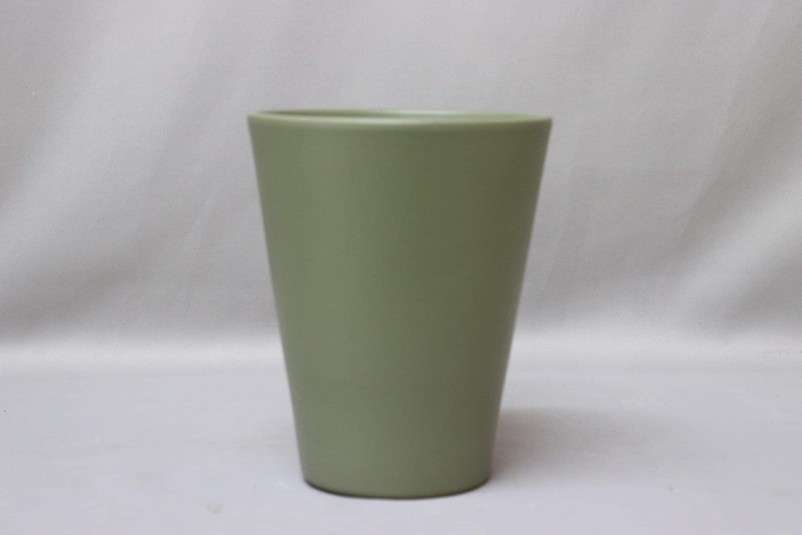 Smooth bottle green pot cover for potted plants.