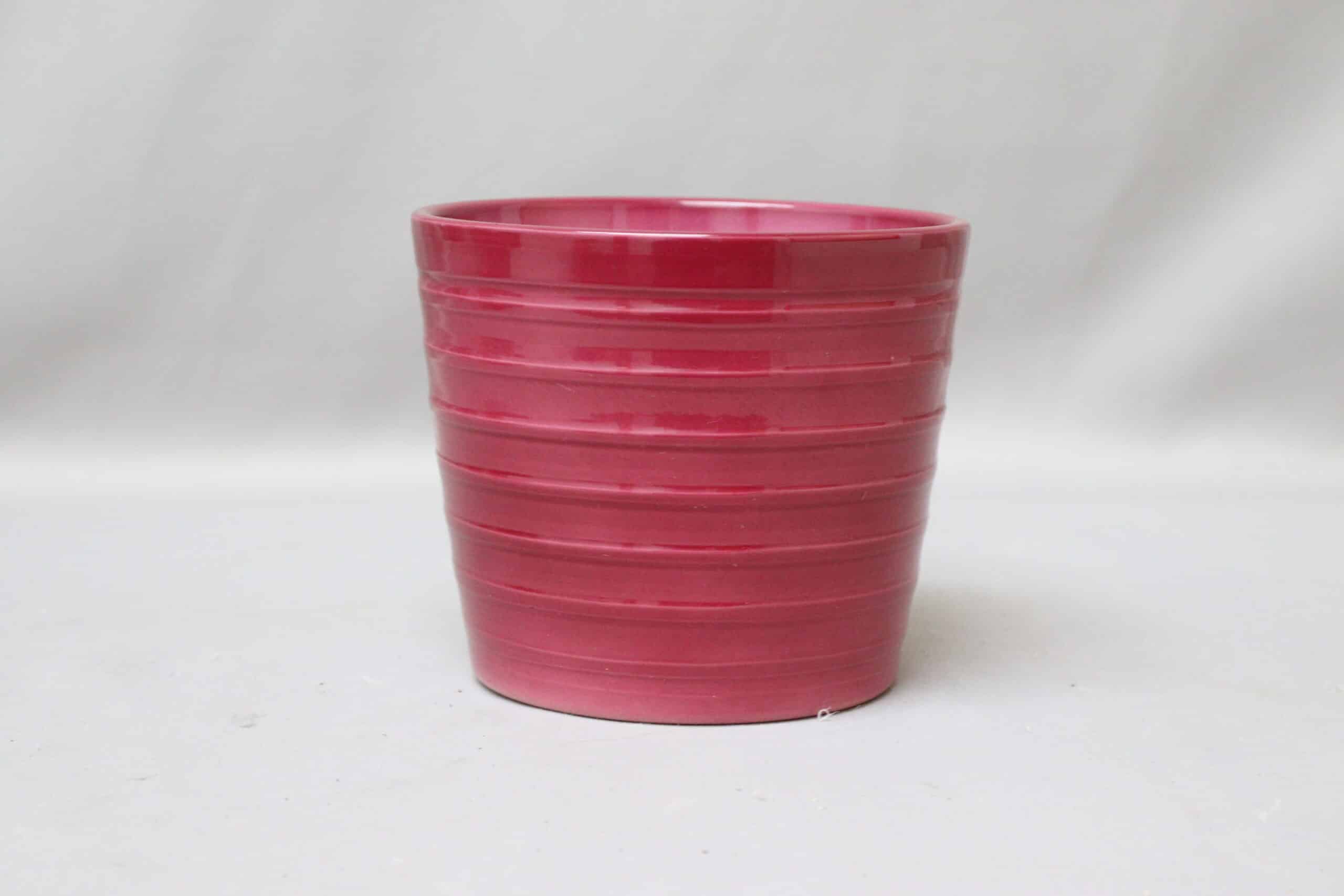 Cerise pink ribbed pot cover for potted plants.