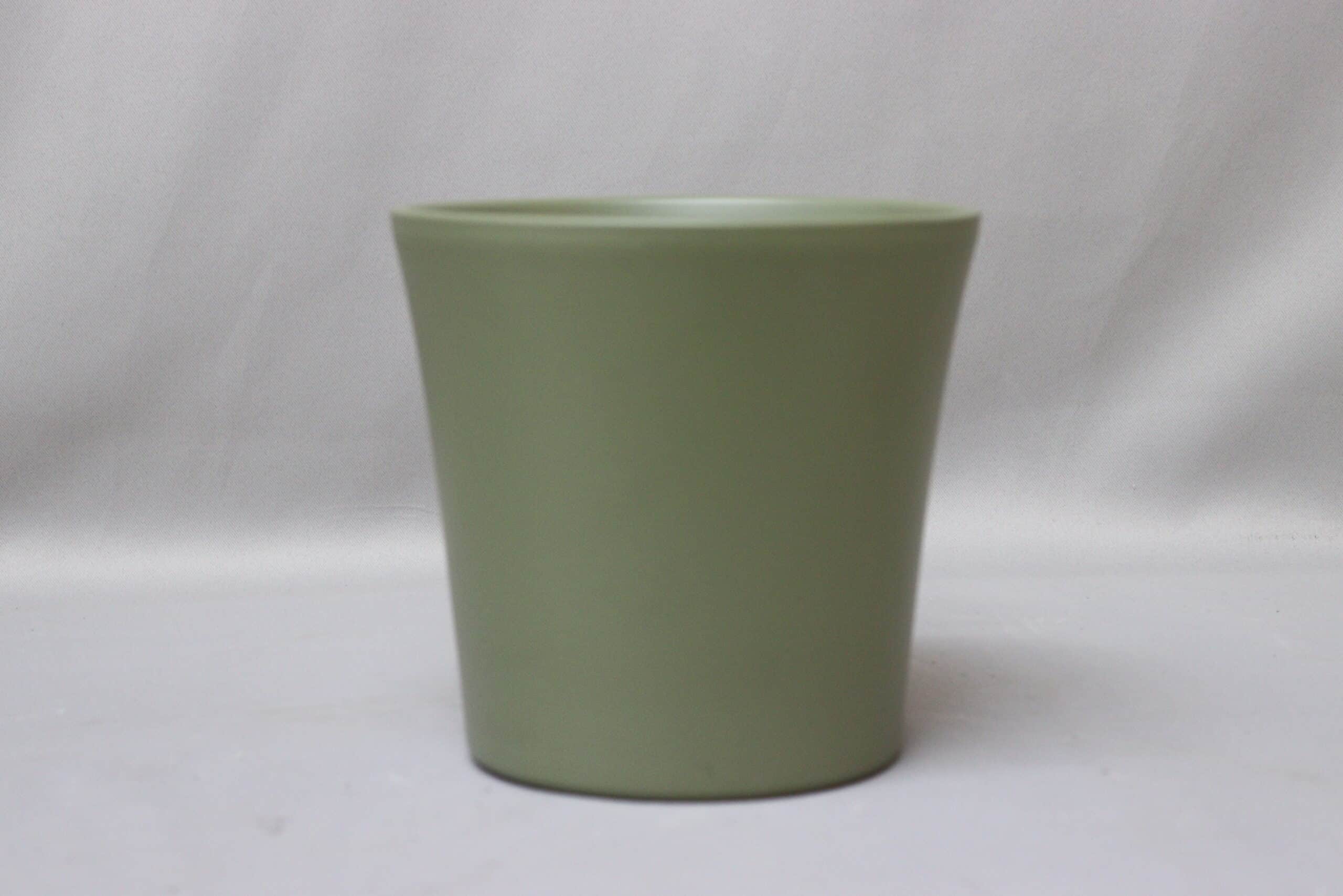 Smooth bottle green pot cover for potted plants.