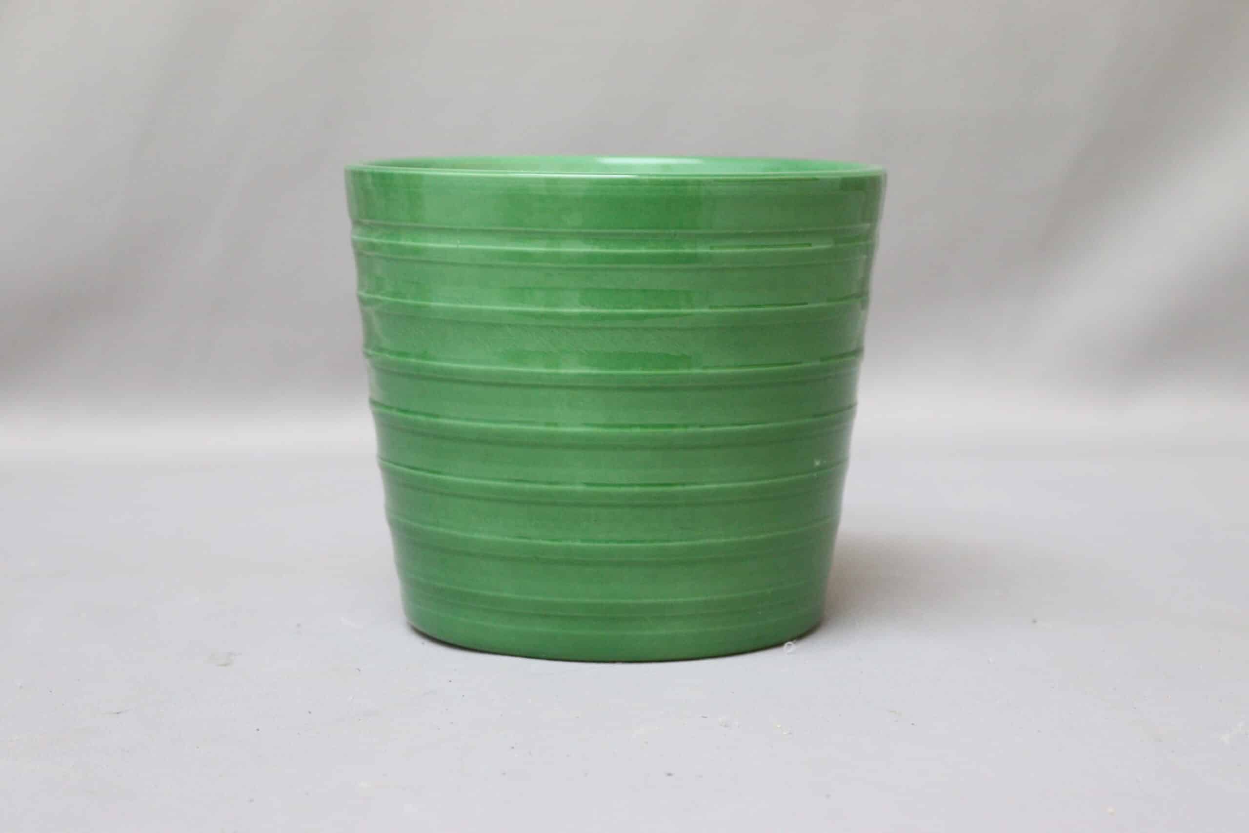 Bright green ribbed pot cover for potted plants.