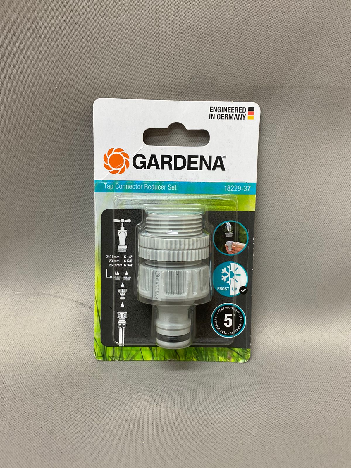 A Gardena brand tap connector reducer in retail packaging against a plain background.